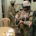 CSM Smith examines evidence gathered during a raid in Zafarania