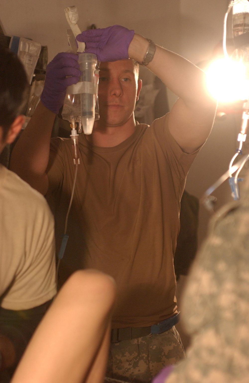 Sgt. Jobes hangs an IV bag