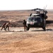 Medics carry a wounded man to a waiting helicopter