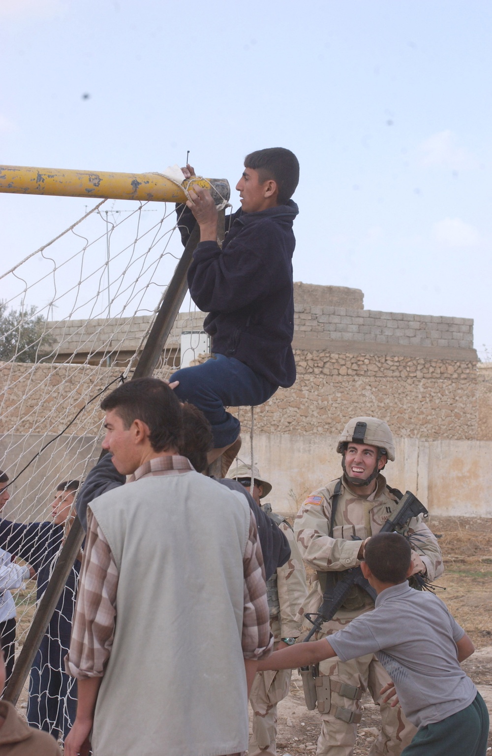 Children Tie a Net Onto New Soccer Posts