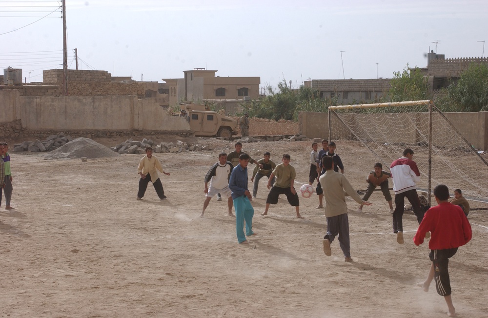 A Group of Iraqi Children Play a Soccer Game