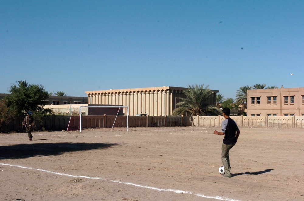 A Local Iraqi Boy Tries Out His Soccer Footwork
