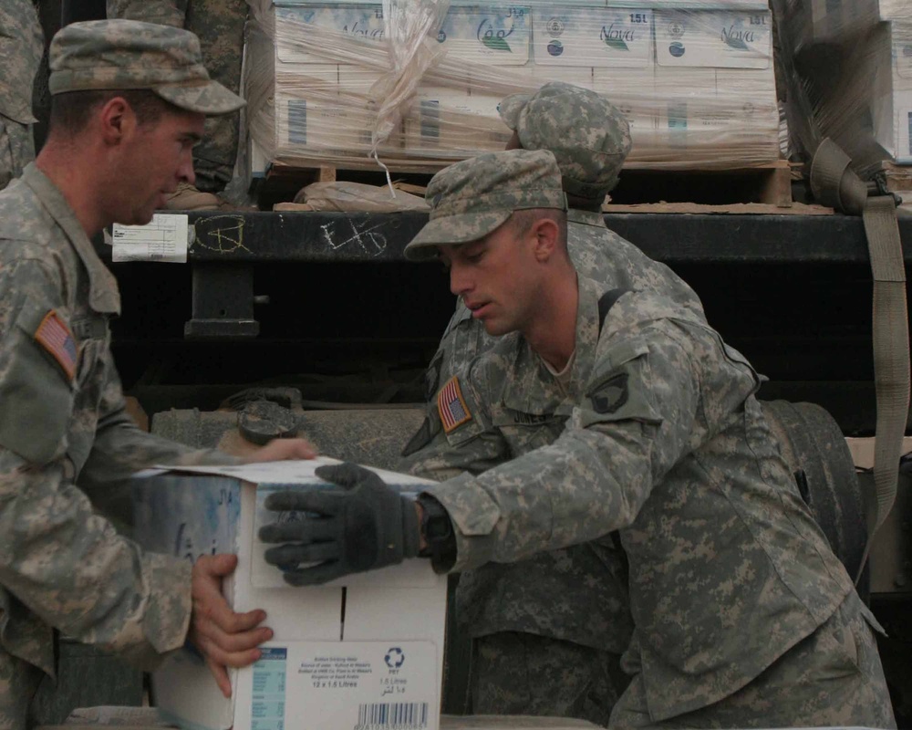 Soldiers unload boxes of bottled water