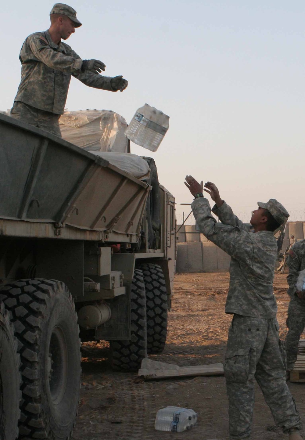 Soldiers unload boxes of bottled water
