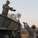 Soldiers unload boxes of bottled water