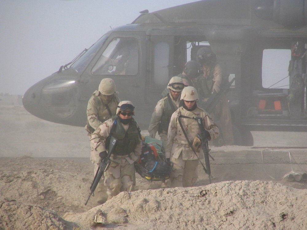 A Rescue Air Mobility Squad practices carrying a litter basket with 200 pou