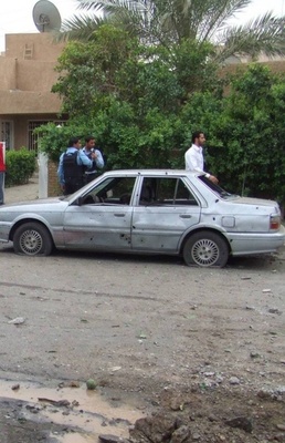 Iraqi police secure the site of a terrorist rocket attack