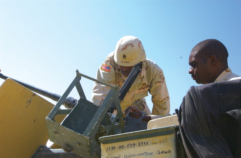 Staff Sgt. Allen and Pfc. Bryant unload and disassemble  the weapon on thei
