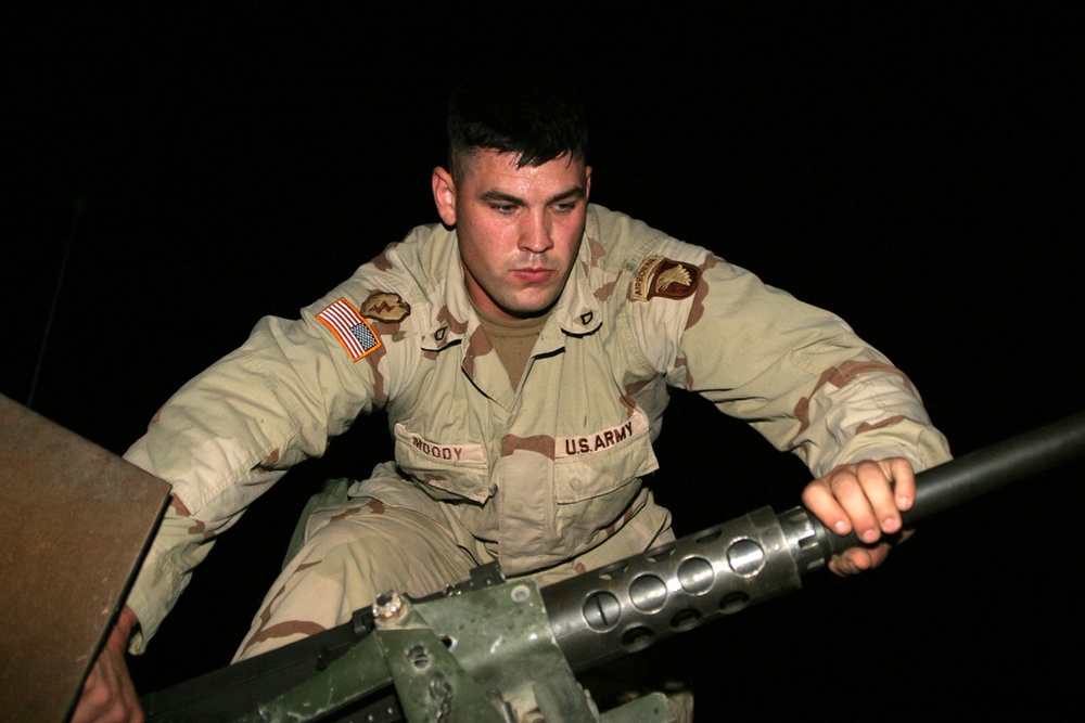 Pfc. Moody attaches the barrel of his M2 .50 cal