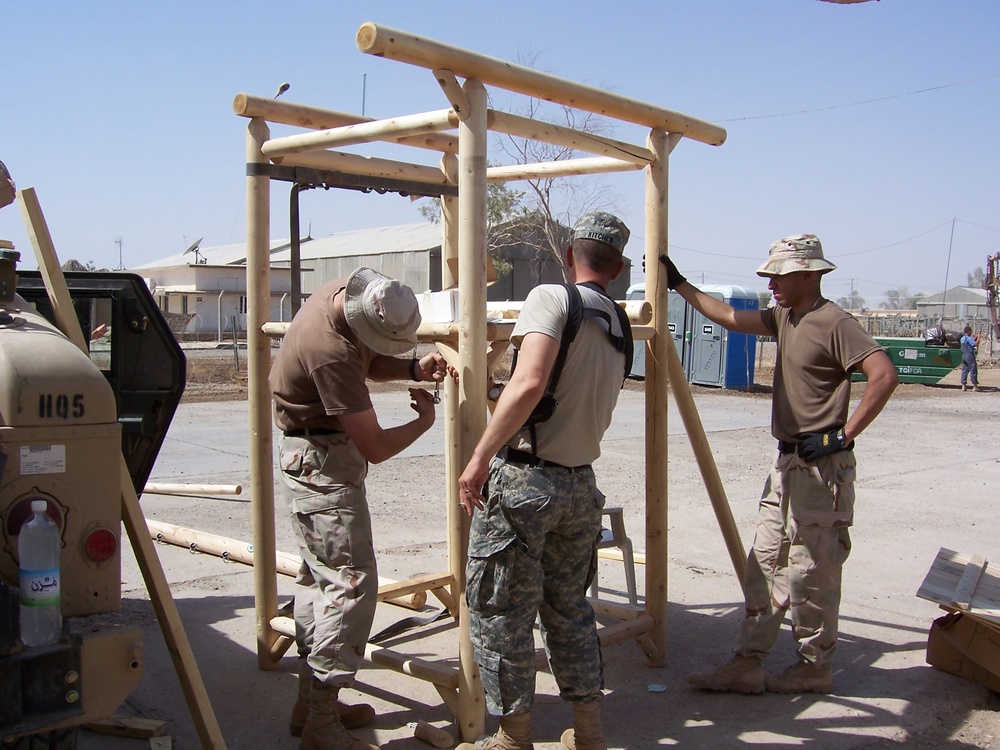 Civil Affairs Soldiers assemble a playground set