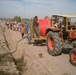 Iraqi workers lay cable