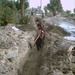 Iraqi workers move cable into a trench