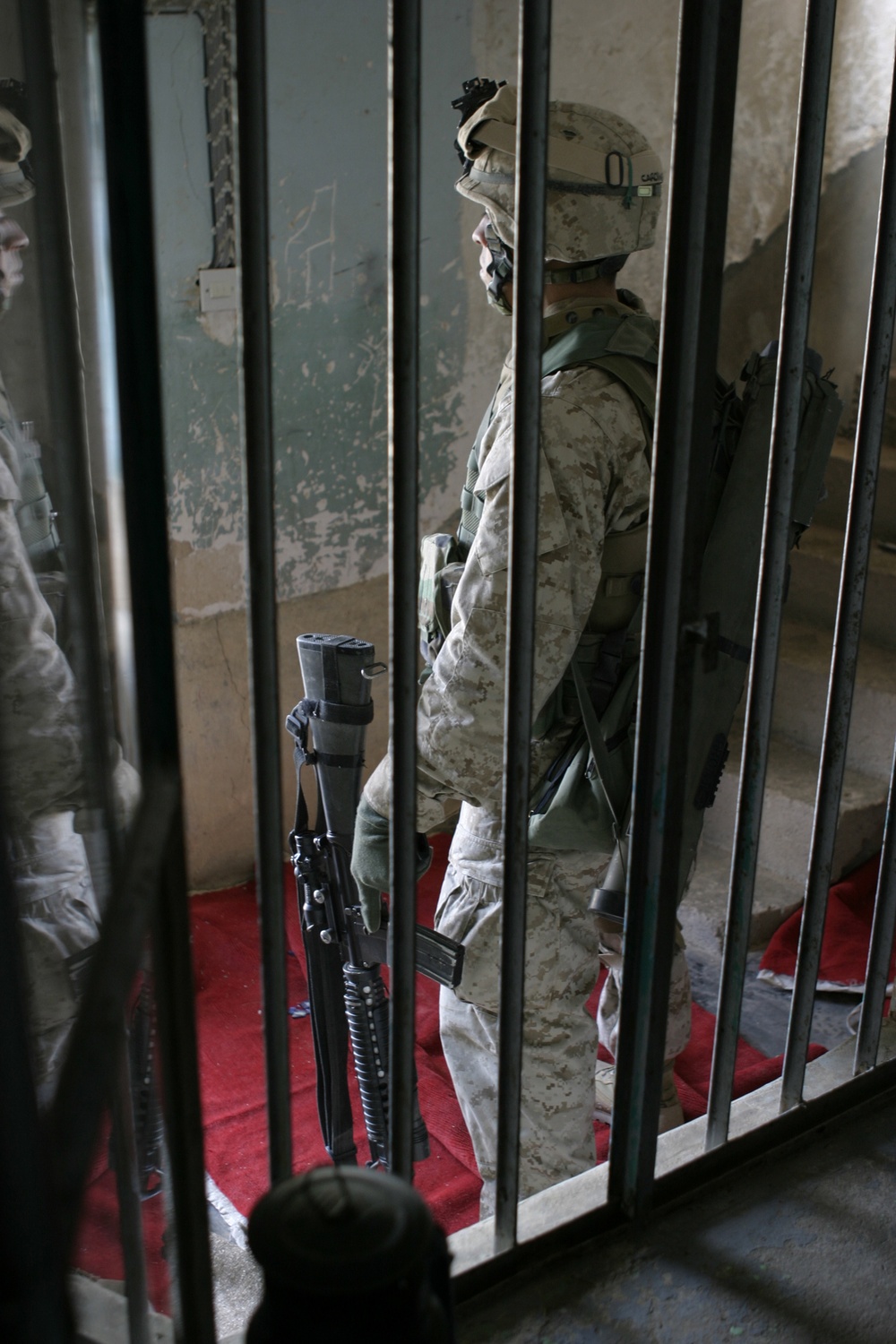 Pfc. Jeorge Z. Lacayo stands guard outside a house in Husaybah