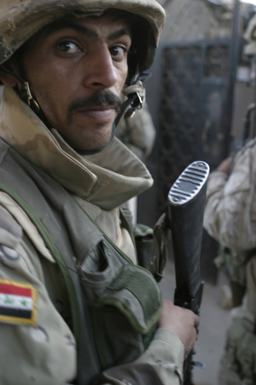 A member of the Iraqi Army prepares to clear a house during Operation Steel