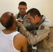 Sergeant David Edwards examines a Iraqi Police Cadet