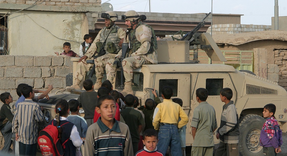 Soldiers escape the crowd of children during a civil affairs mission
