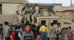 Soldiers escape the crowd of children during a civil affairs mission