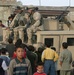 Soldiers escape the crowd of children during a civil affairs mission