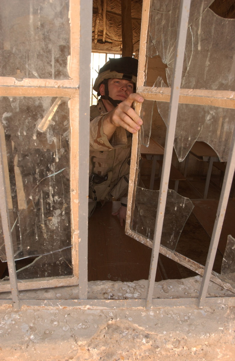 Major David Motes inspects a local schoolhouse