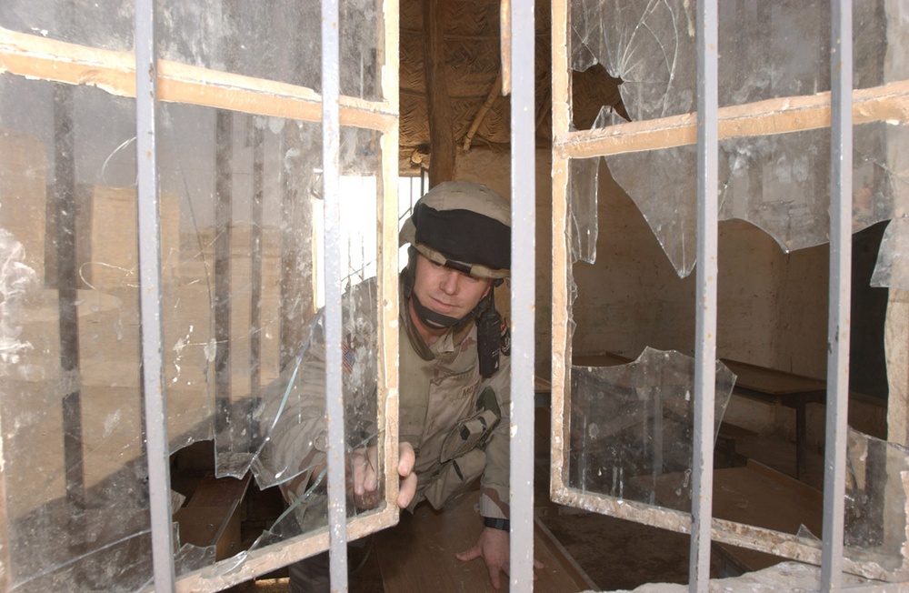 Major David Motes inspects a local schoolhouse