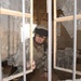 Major David Motes inspects a local schoolhouse