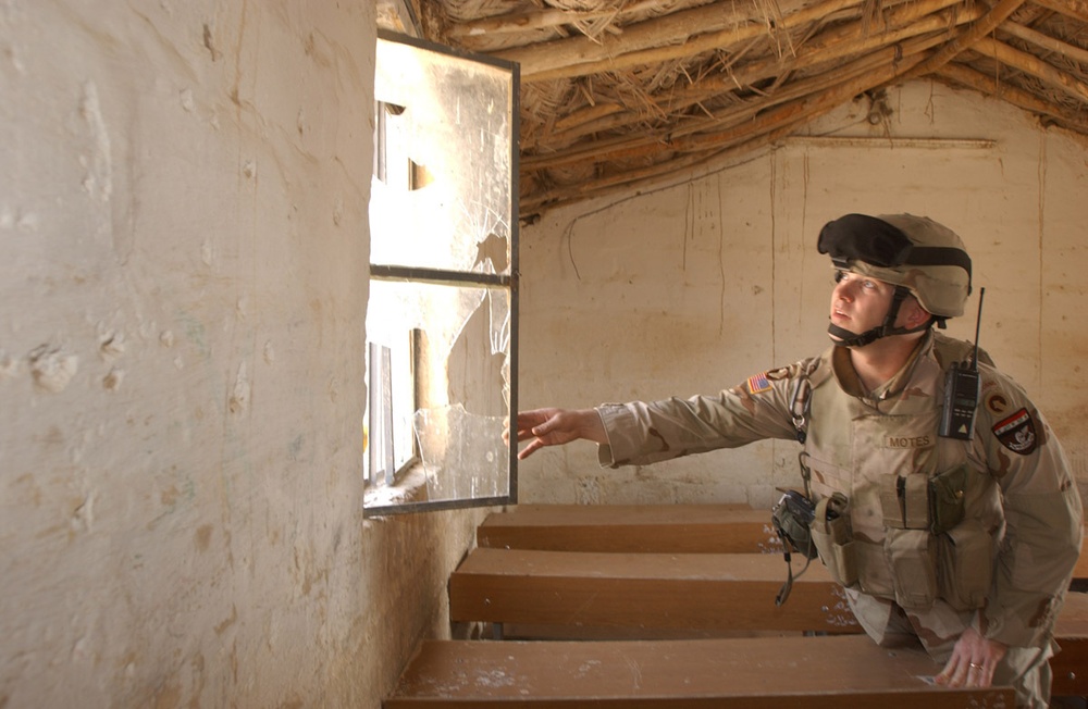 Major David Motes inspects a local schoolhouse