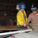 Sgt. Mendenhall and Pvt. Trinidad mark heavy metal sheets for cutting