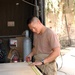 Pvt. Dan L. Trinidad measures and marks a sheet of heavy metal