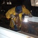 Sgt Alan D. Mendenhall welds armor to the bed of an Iraqi police vehicle