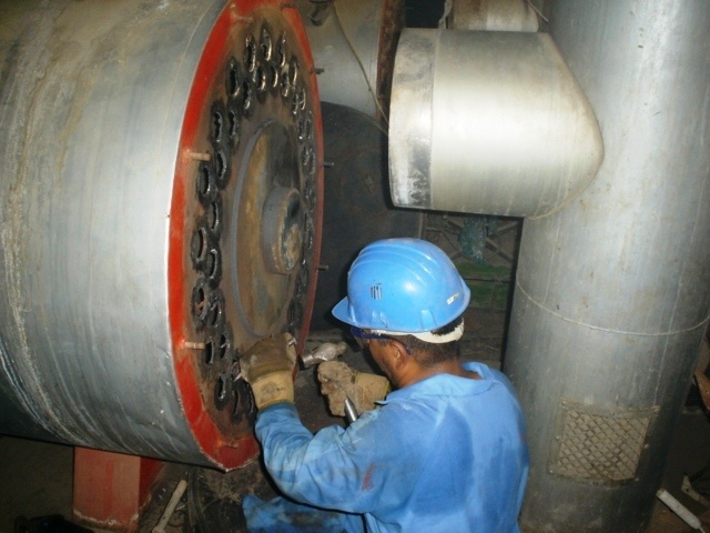 An Iraqi worker overhauls the boilers at Ibn Al Baladi Hospital