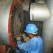 An Iraqi worker overhauls the boilers at Ibn Al Baladi Hospital