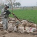 Sgt. 1st Class Cozad examines a weapons cache