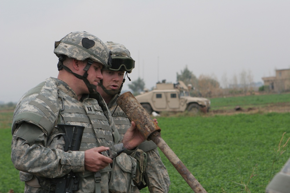 Capt. Matt Ruckman and Staff Sgt. Joel Killian inspect firing devices