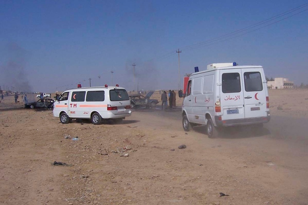 Iraqi ambulances rush to the scene of a car bombing