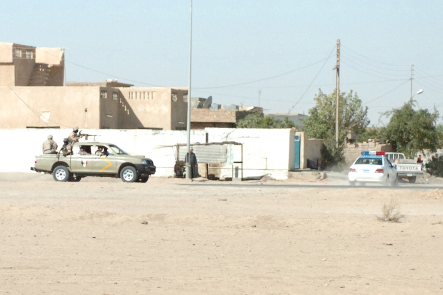 Iraqi Army personnel respond to the scene of a car bombing
