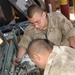 Soldiers repair humvee