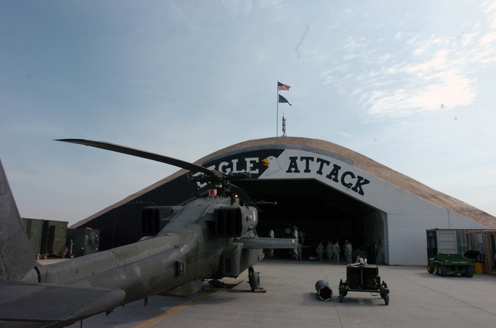 AH-64 Apache sits outside a hangar