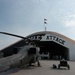 AH-64 Apache sits outside a hangar