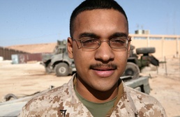Lance Cpl. Latchman stands in the motor pool