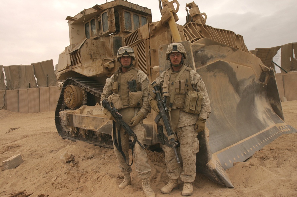 CW4 Clyne and MSG Witmer stand in front of a D9 bulldozer