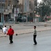 Children play soccer in the deserted streets of Baghdad