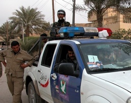 An Iraqi police vehicle outside a polling station