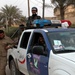 An Iraqi police vehicle outside a polling station