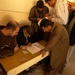 Voting officials check an Iraqi mans identification card