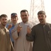 Iraqi citizens show their inked index fingers