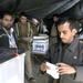 An Iraqi man folds is ballot