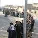 Iraqi men wait to enter the polling sites