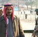 An Iraqi man smiles as he walks into the polling center