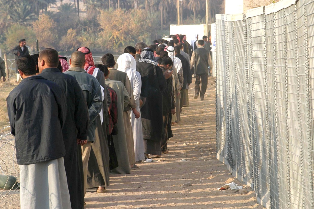 Iraqi voters stand in line