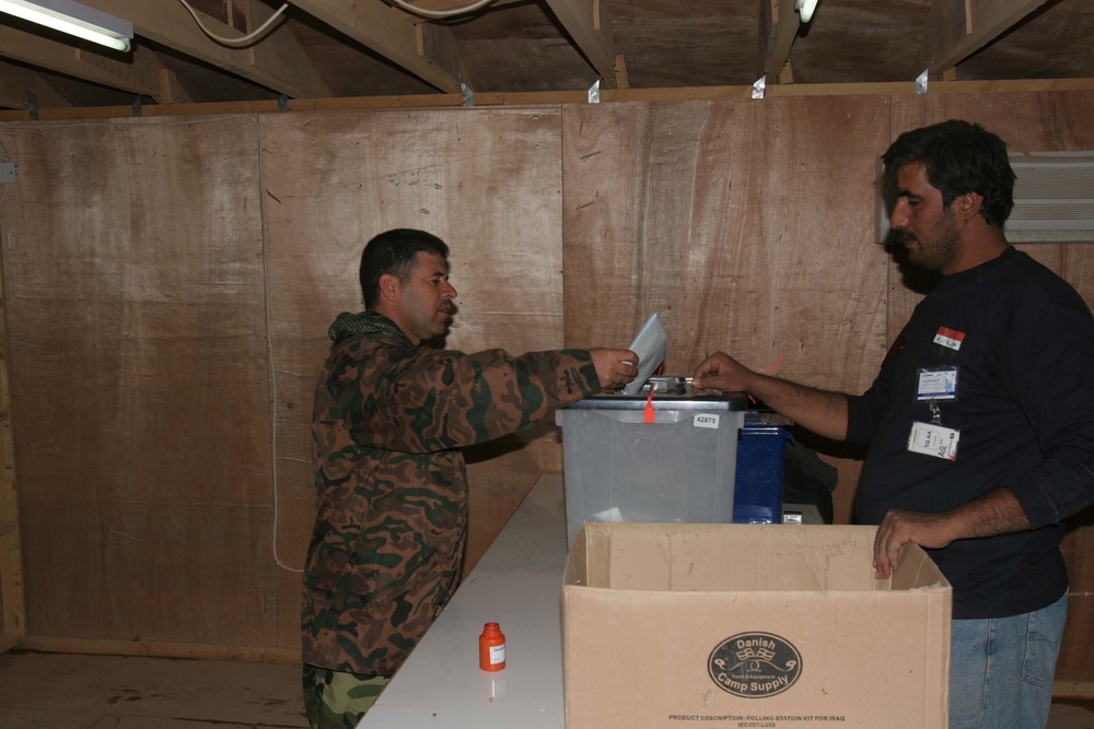 Colonel Rizak Saleem drops a ballot in the ballot box